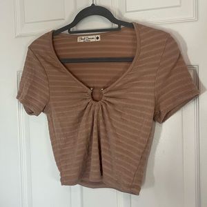 Light tan cropped shirt with silver ring